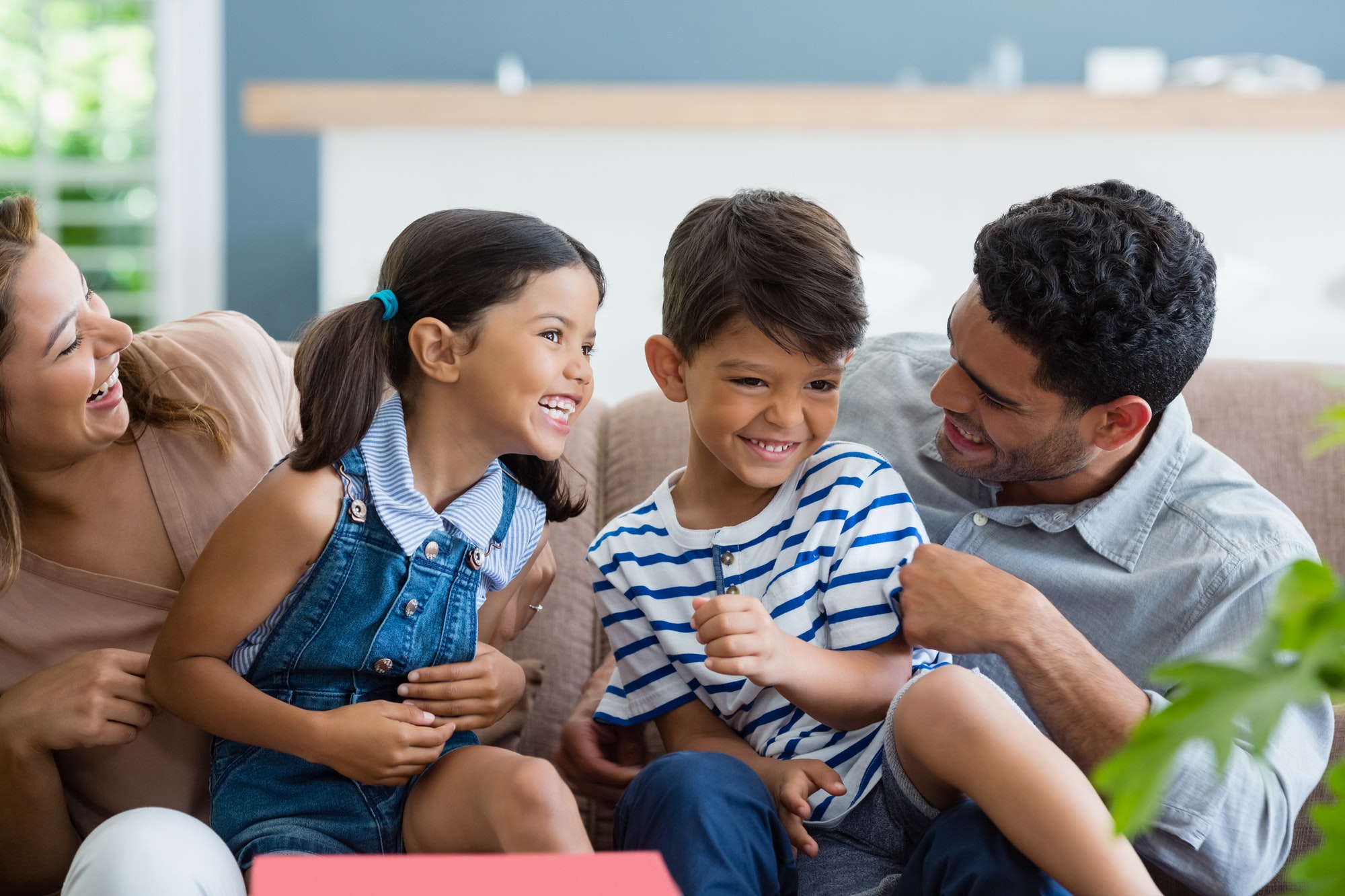 Parents and kids having fun in living room